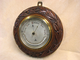 Edwardian Art Nouveau style wall barometer with thermometer in oak surround